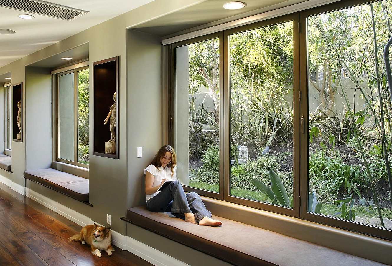 Woman exploring ideas in front of folding glass window