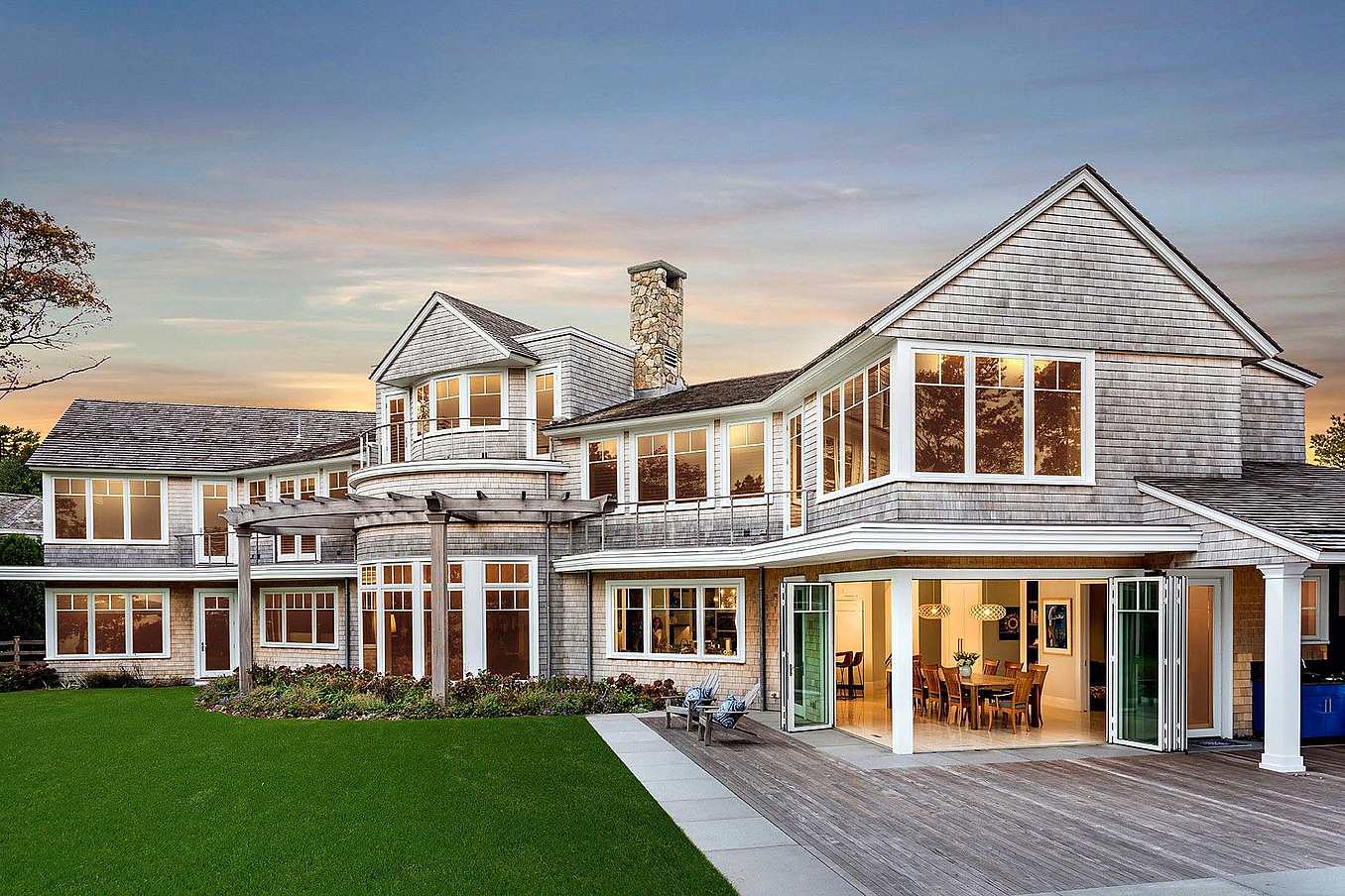 folding glass walls in traditional homes creates indoor/outdoor experience