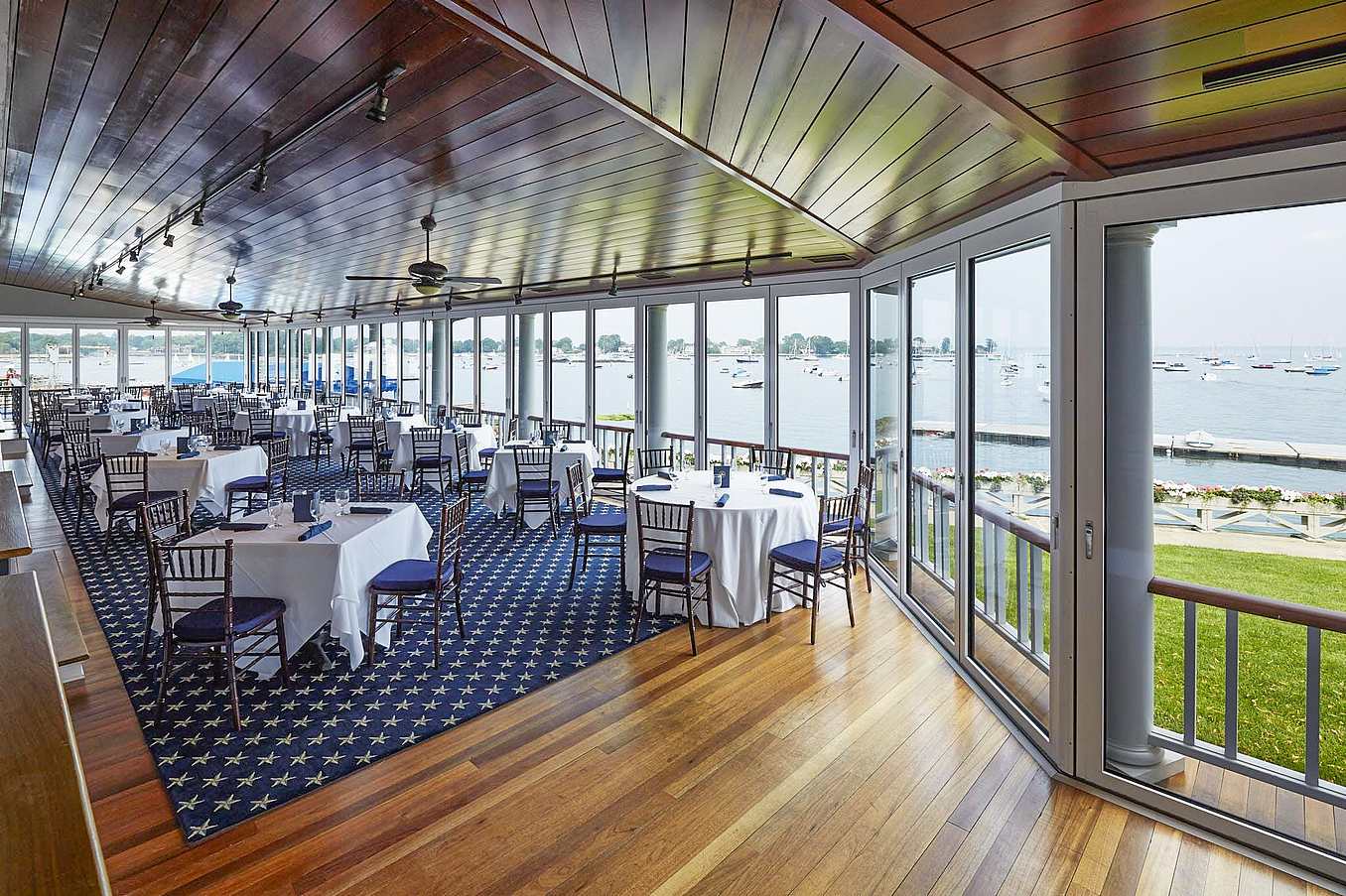 indoor outdoor dining at country club with commercial glass walls