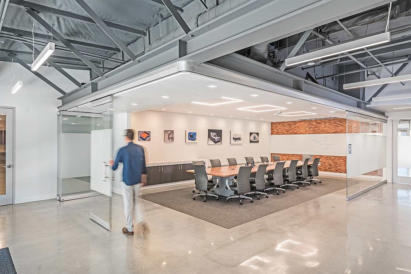 frameless opening glass wall system in workspace