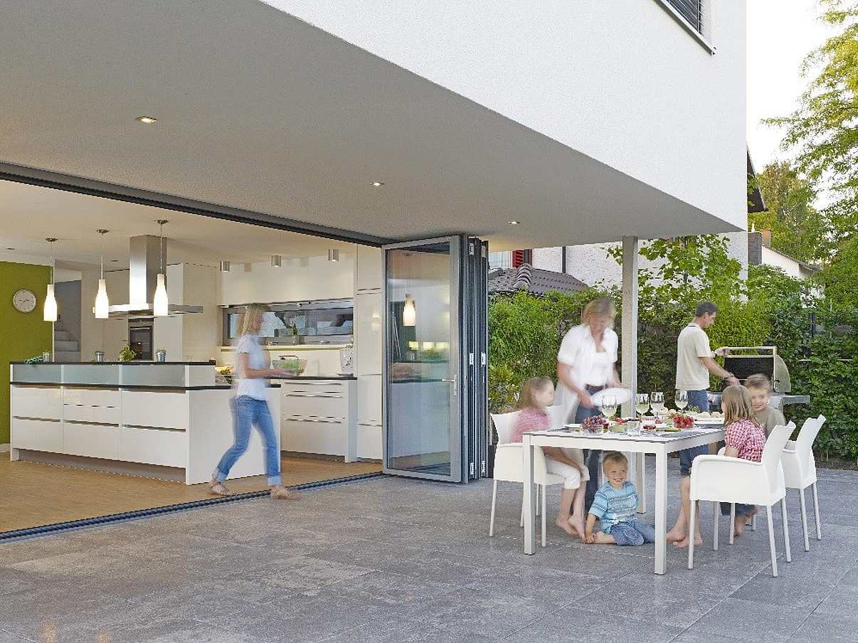 Family enjoying indoor/outdoor kitchen.