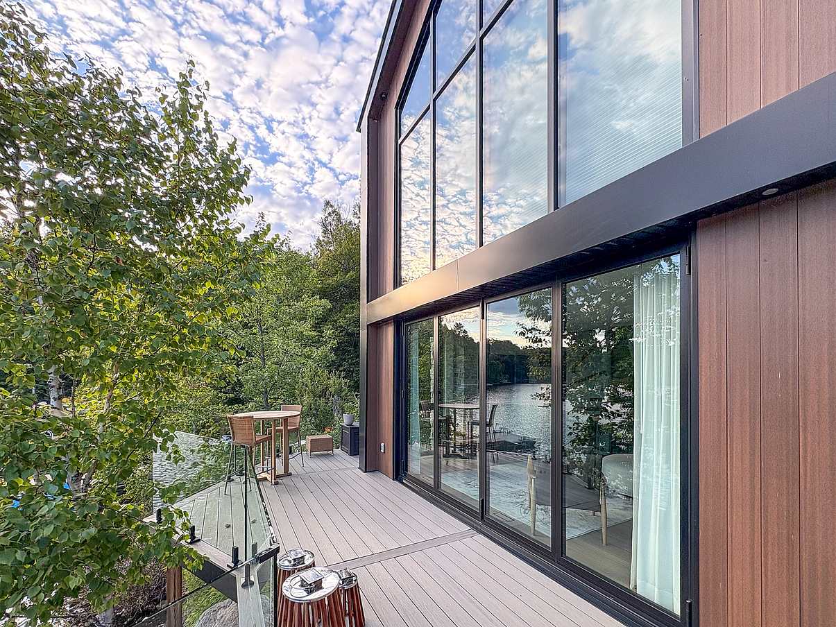 folding glass door in waterfront home design