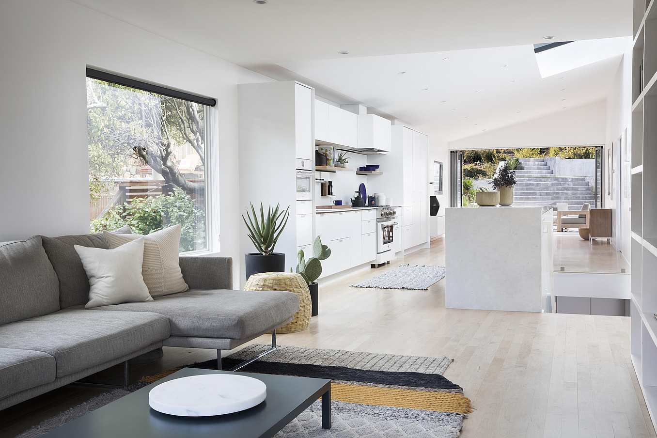 remodeled home with open concept living and opening glass wall