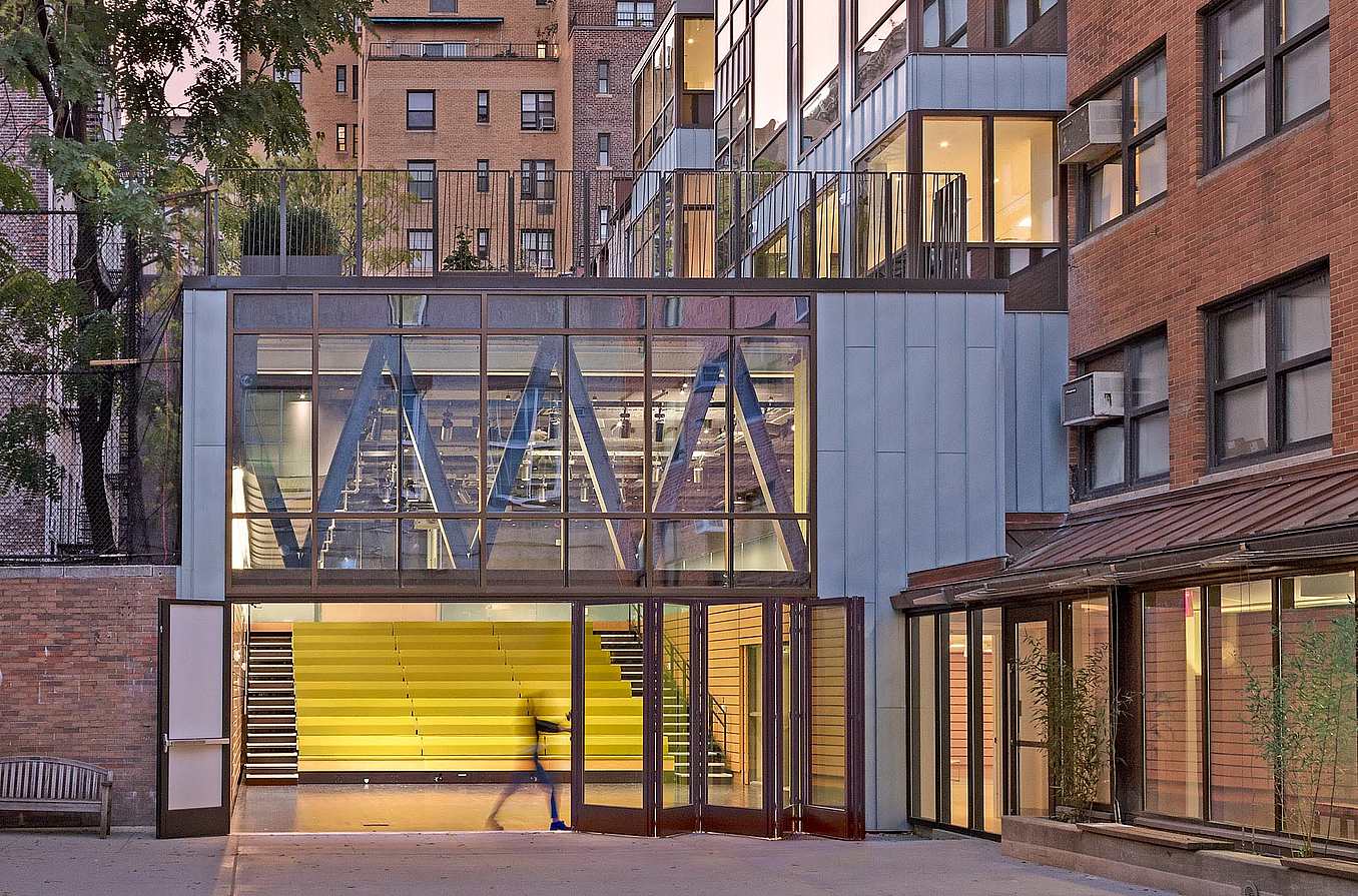 teacher opening folding glass wall in 21st century school design