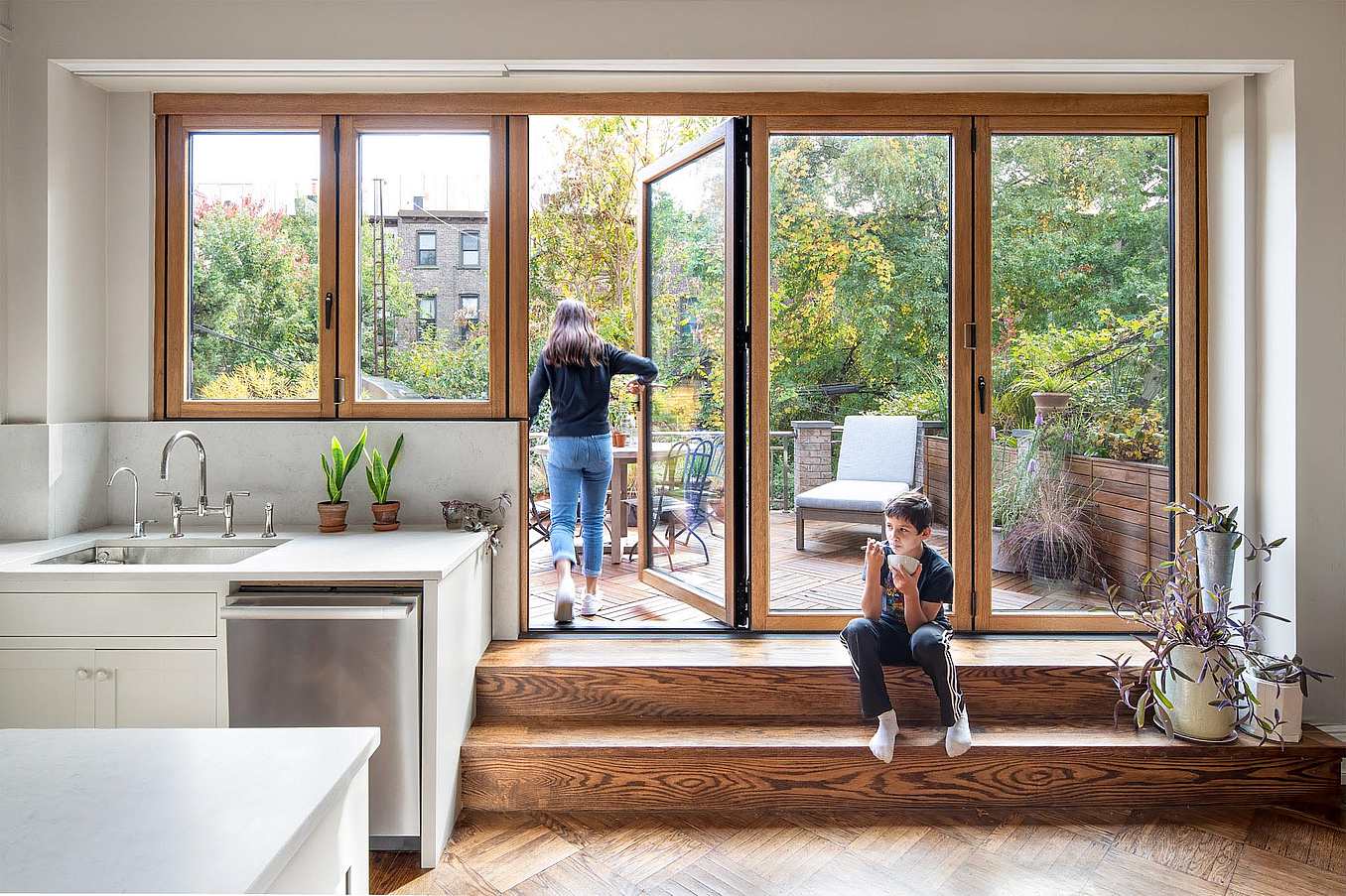 small kitchen renovation with swing door in folding glass wall