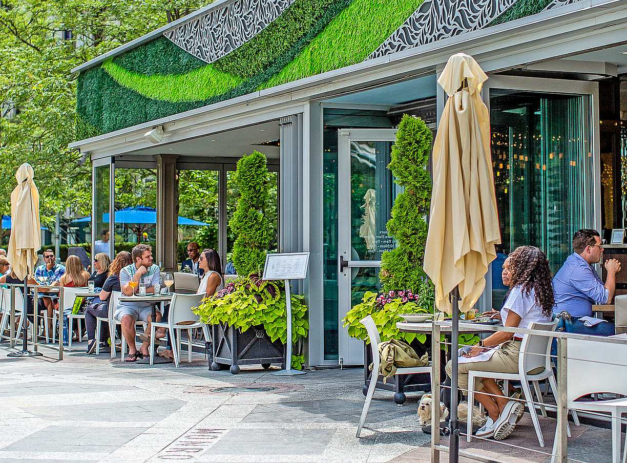 indoor outdoor restaurant with exterior stacking glass doors attracts customers