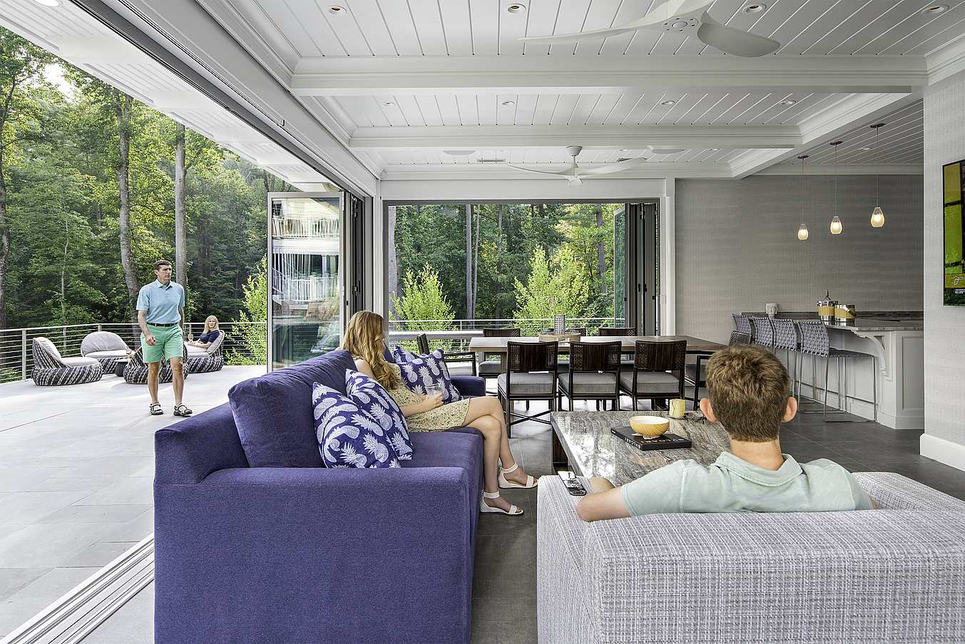 inside pool house with open folding glass wall systems