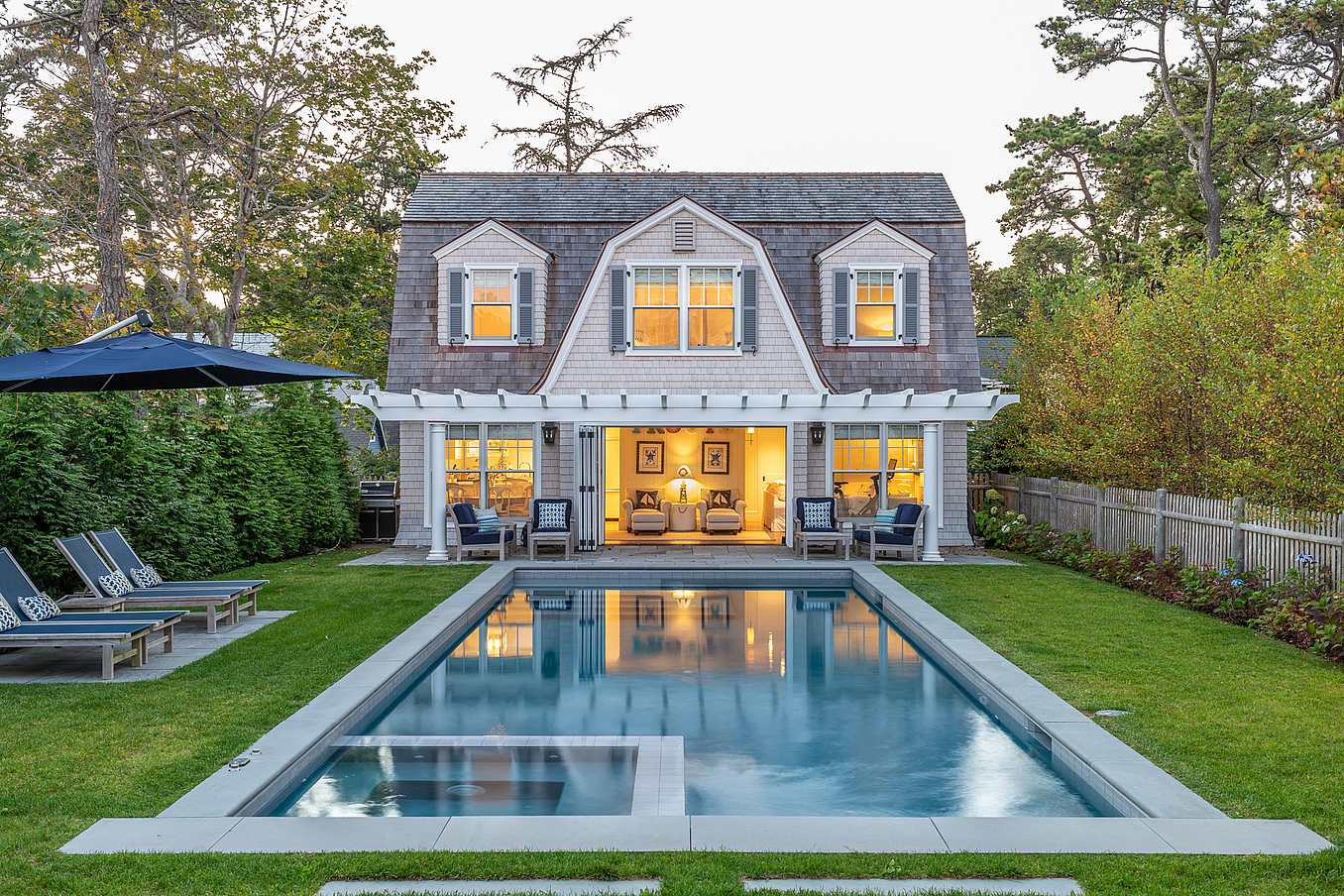 traditional pool house with operable glass walls