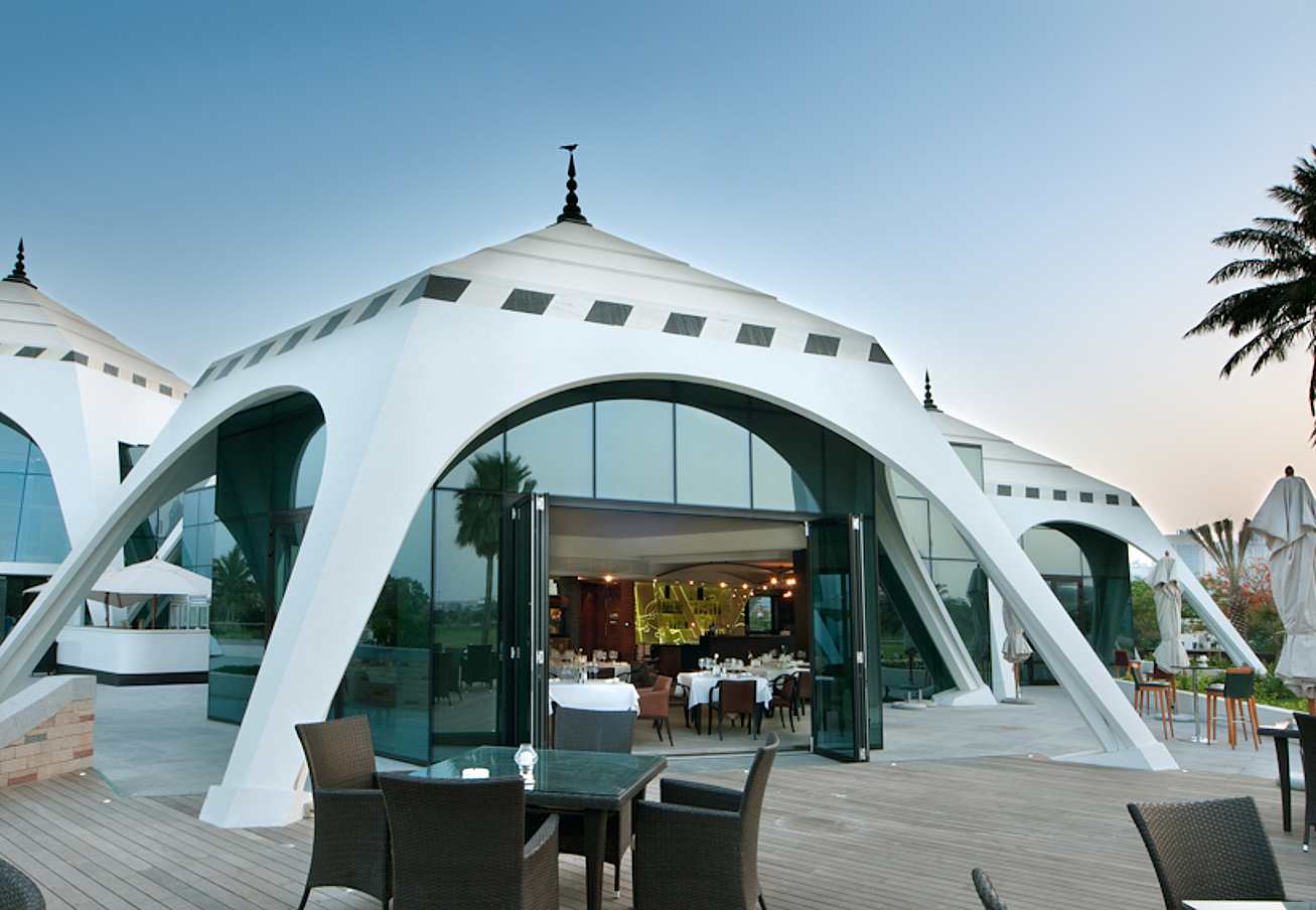 pyramid-shaped-golf-club-venue-with-opening-glass-wall