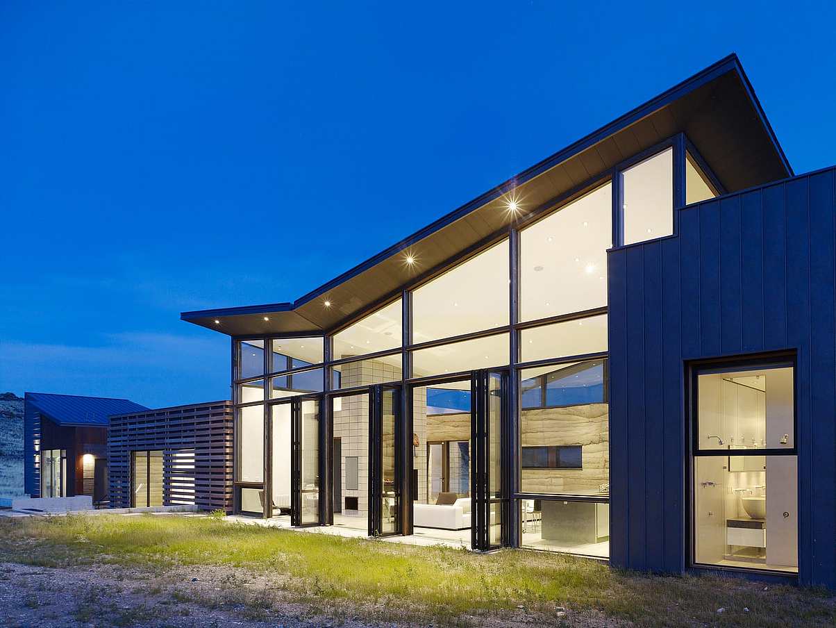 lit-up-house-with-open-glass-walls-and-glazing