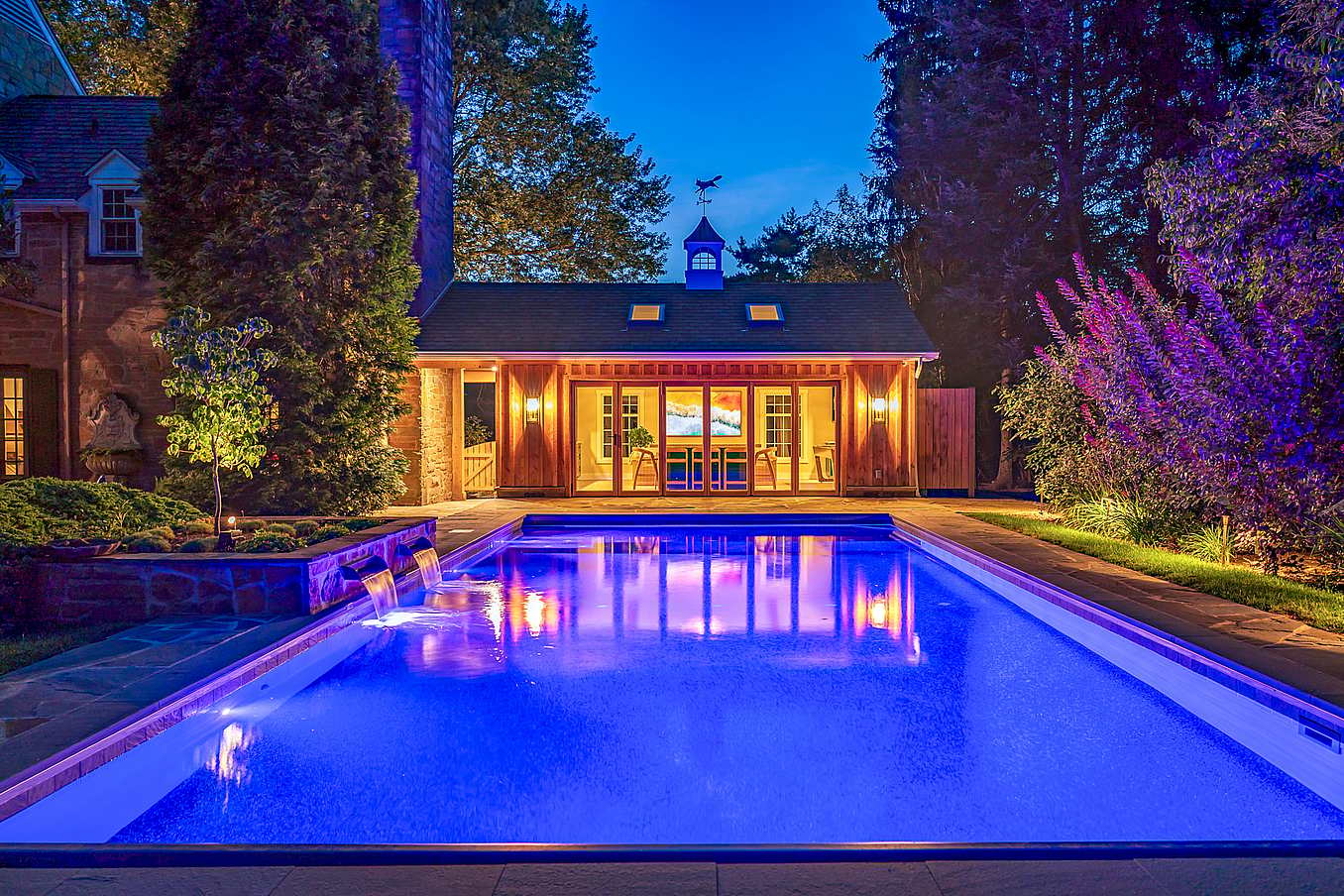 outdoor living with pool house and wood framed folding door