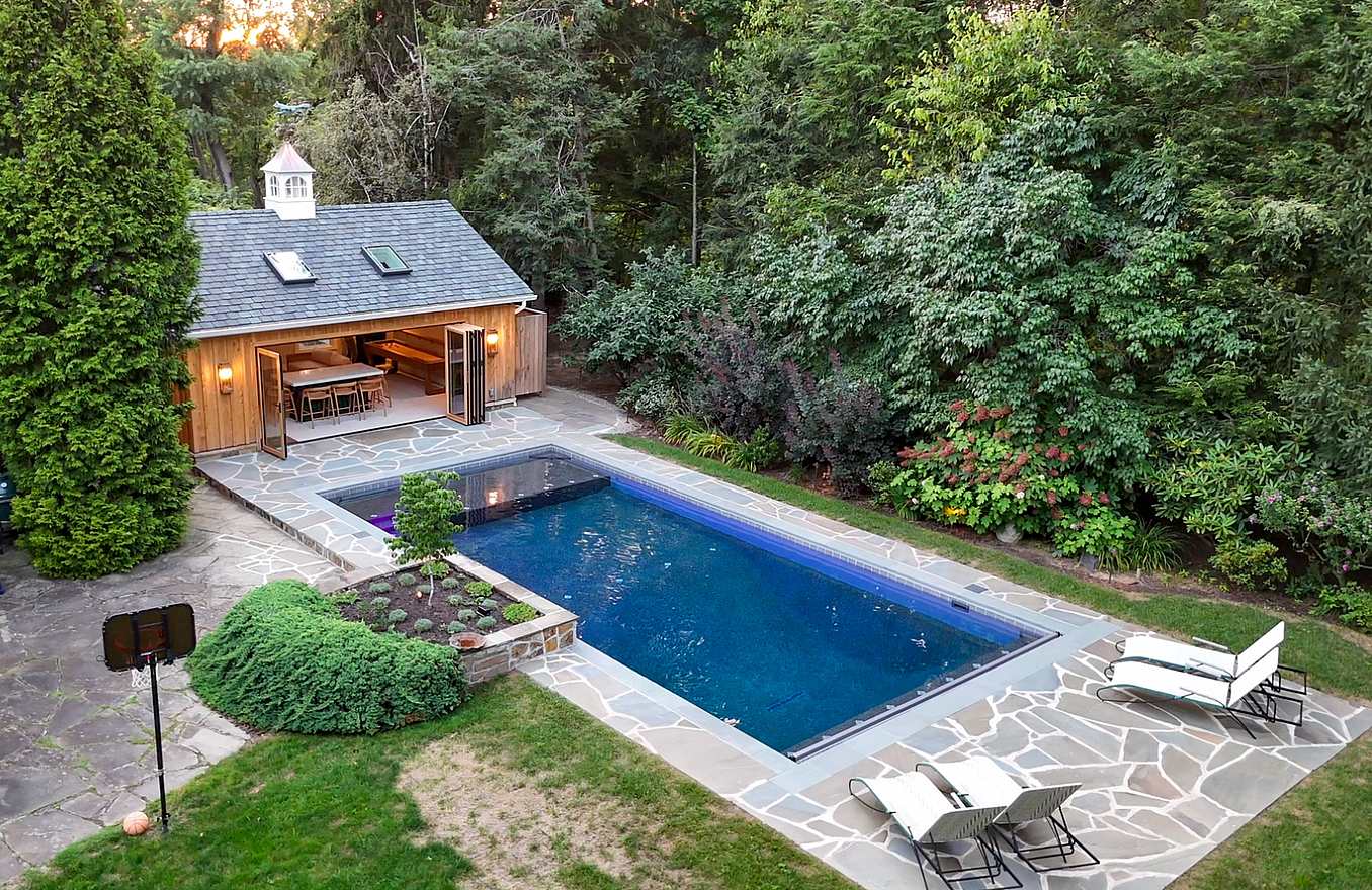 contemporary pool house design with wood framed bifold door system