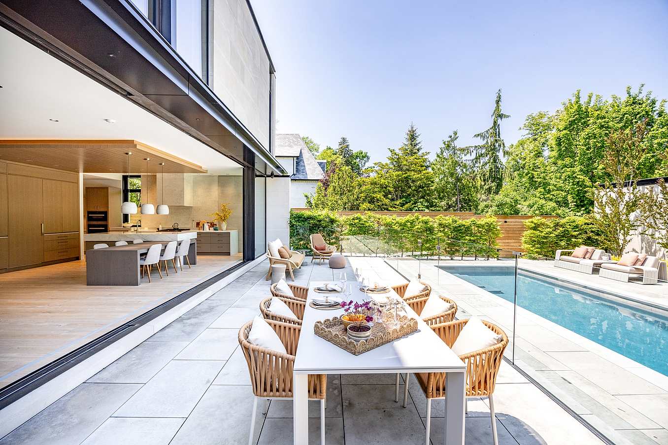 indoor outdoor living with minimal sliding glass wall system