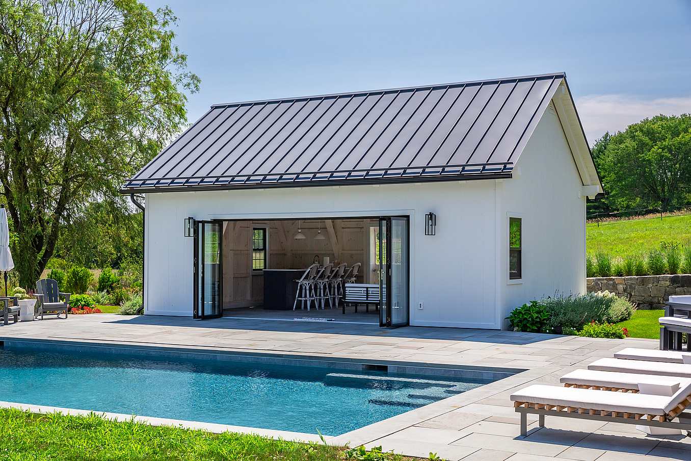 Pool house design with folding glass walls