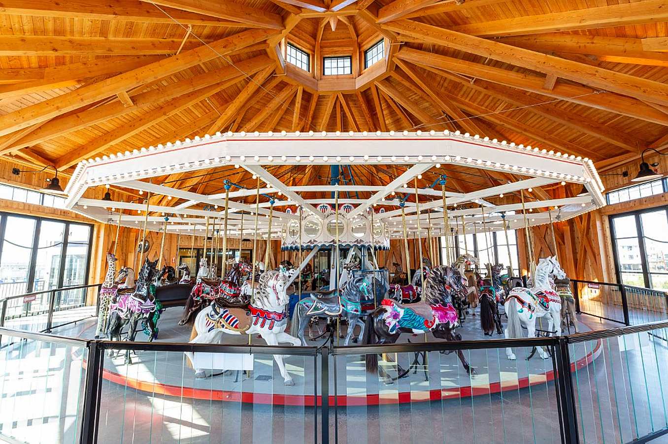 commercial folding glass walls around a carousel in barn like structure