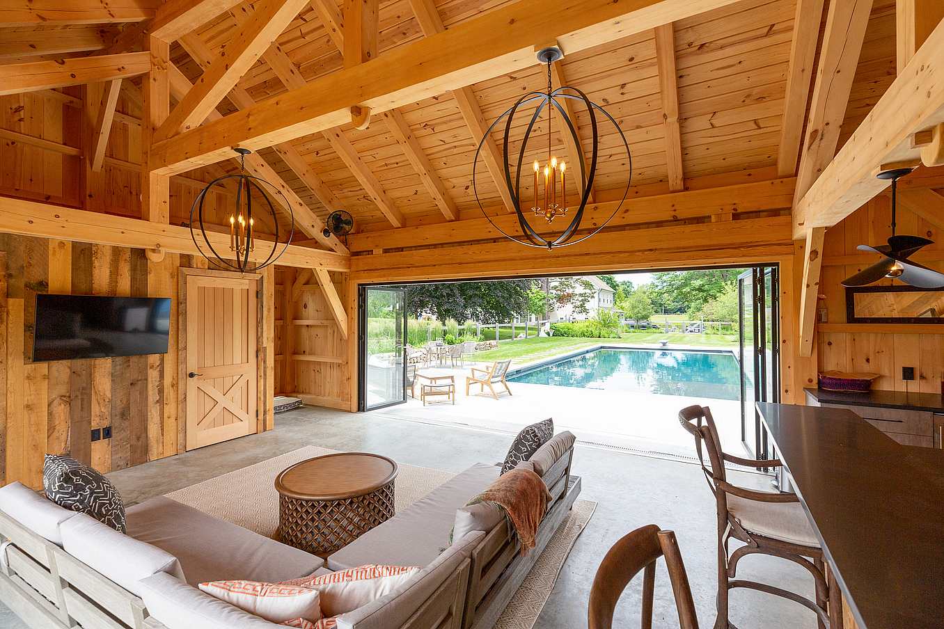 Barn Yard pool house design with NanaWall folding glass wall
