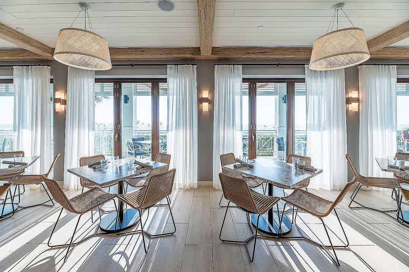 Miami-Dade hurricane-rated folding glass walls in hotel setting