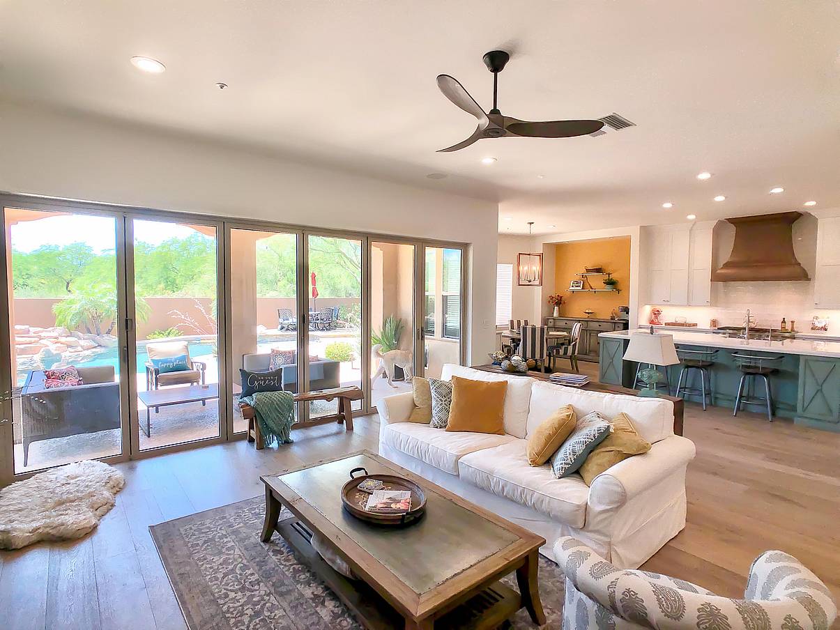 remodeled room with folding glass walls allowing indoor/outdoor lifestyle
