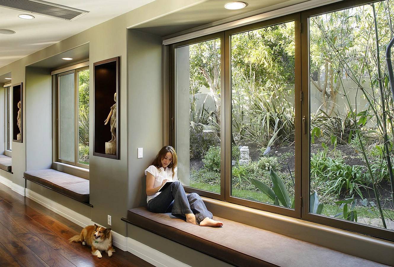 Woman exploring ideas in front of folding glass window