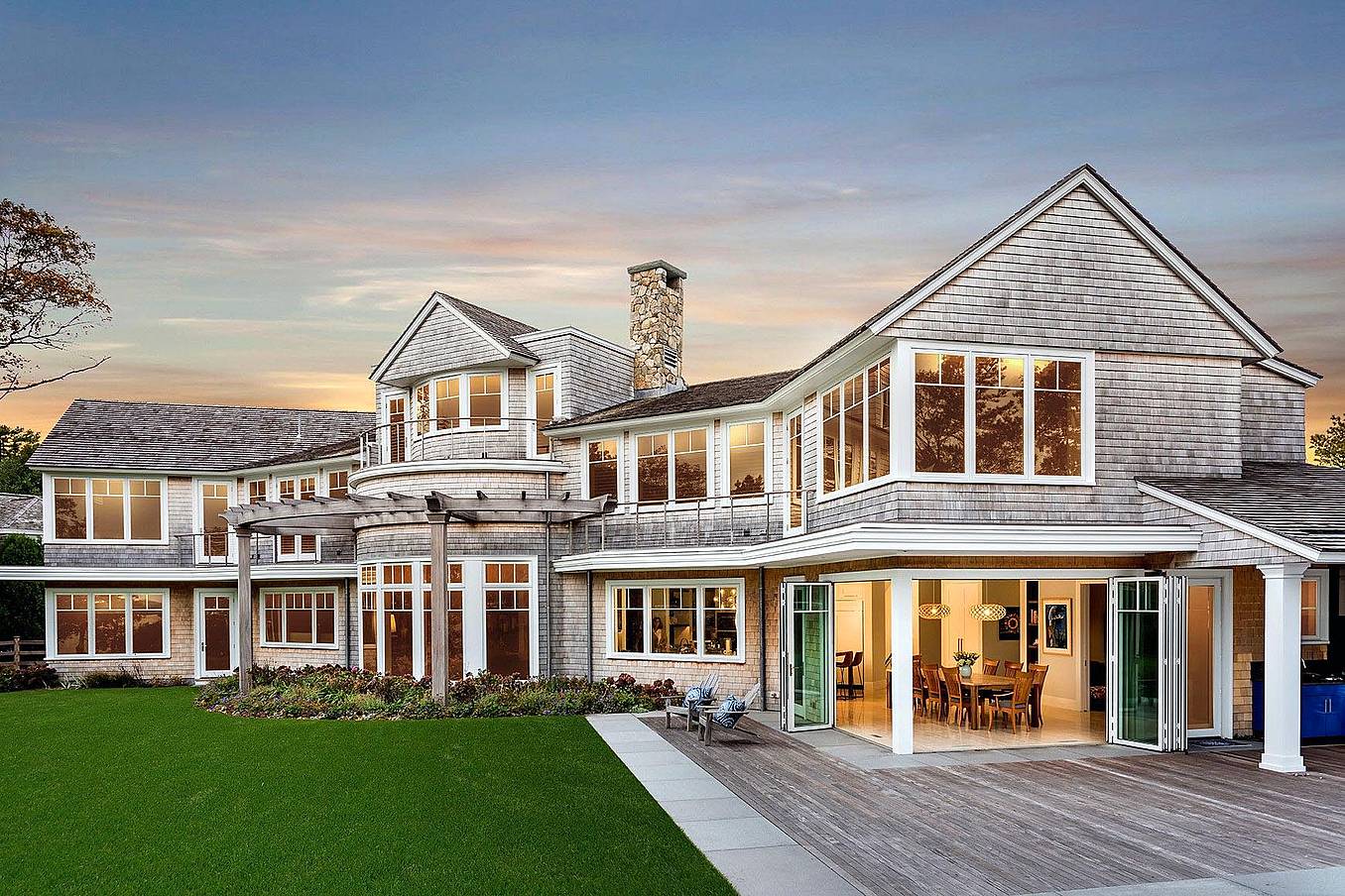 folding glass walls in traditional homes creates indoor/outdoor experience