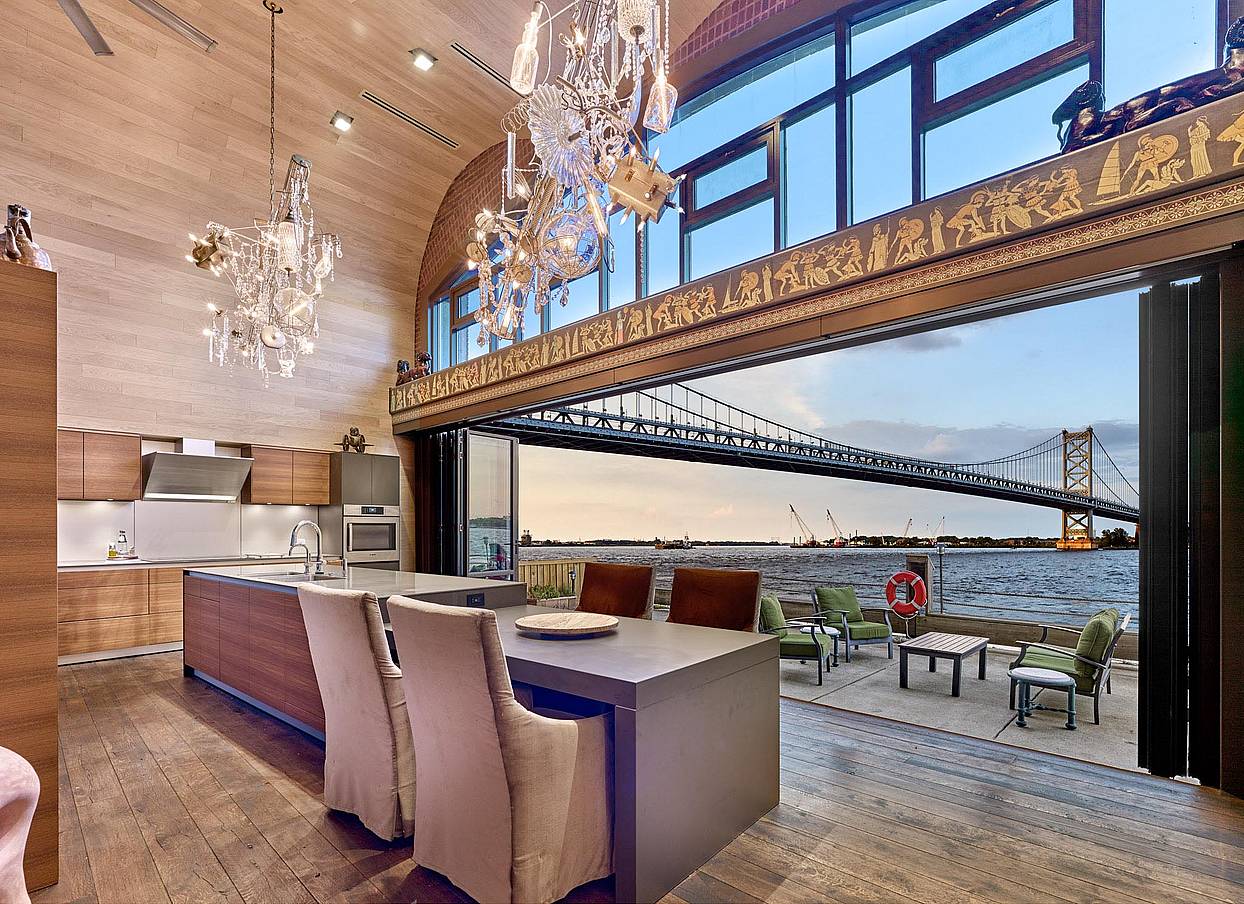 grand philadelphia kitchen with bridge view through opening glass wall