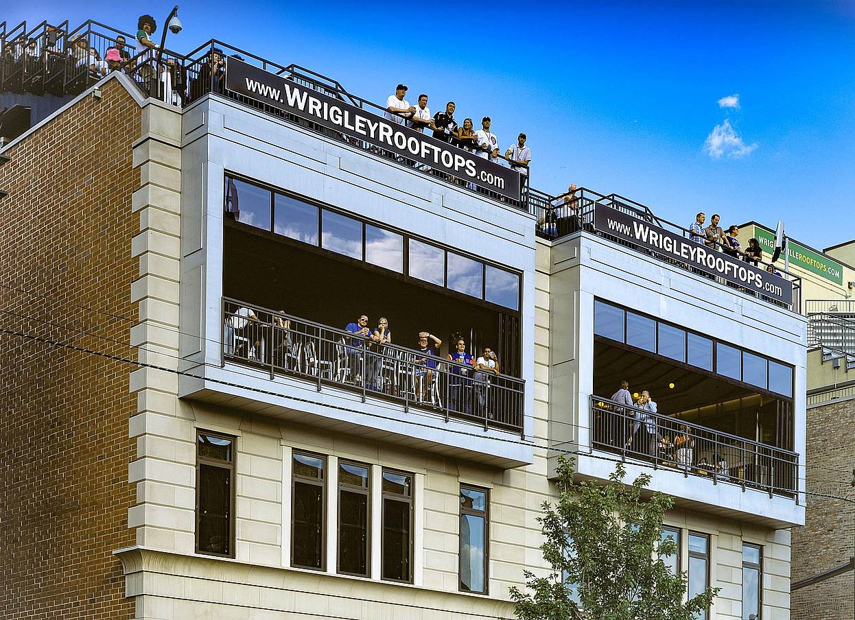 wrigley rooftops with folding glass walls open for viewing live games of baseball with patrons