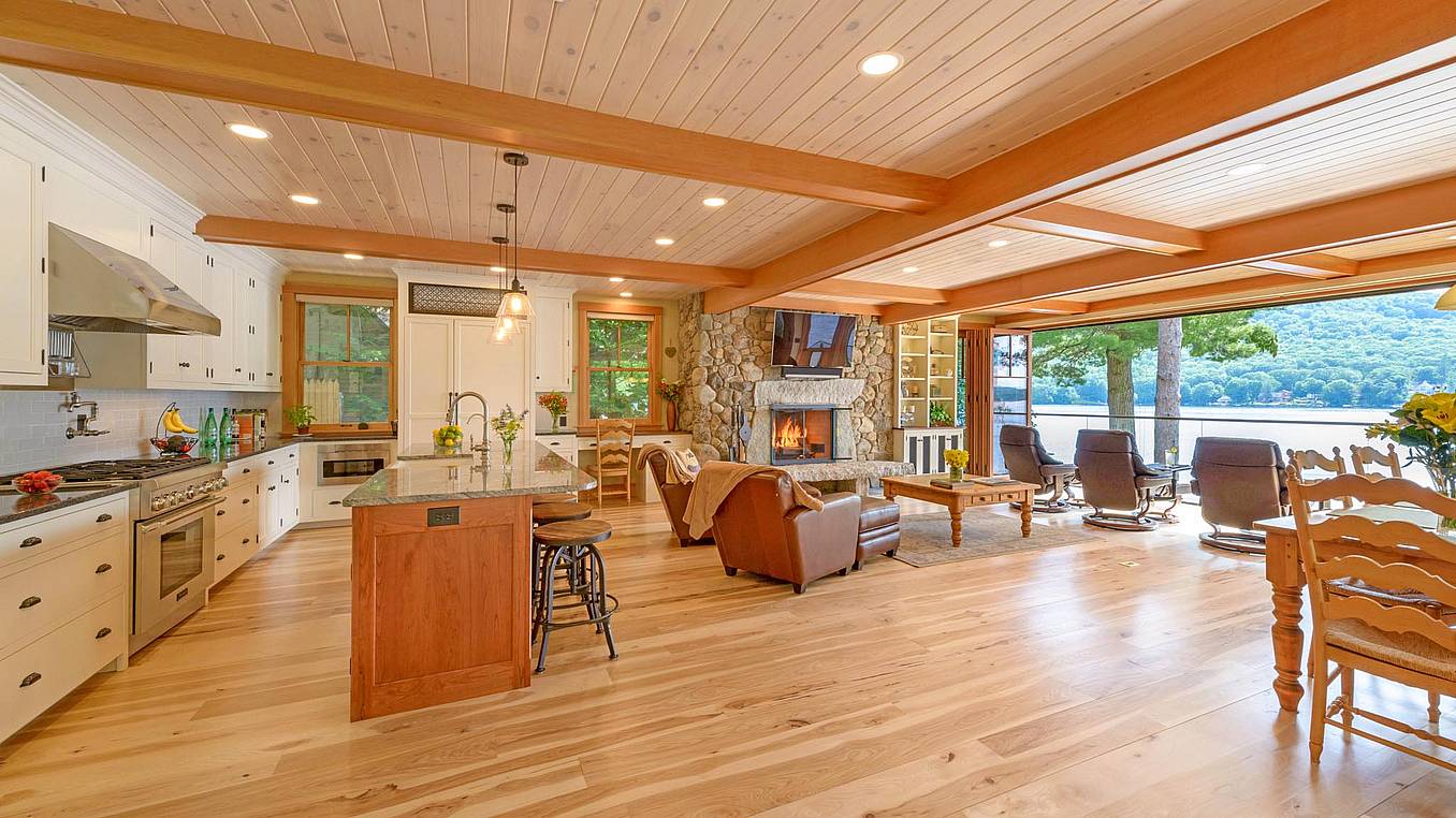 lakefront living room remodel with wood framed bifold door and view