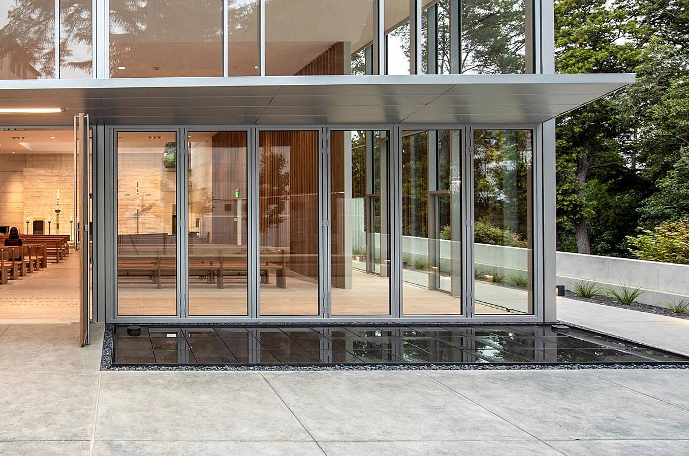 closed folding glass wall at saint mary's college high school in its student chapel