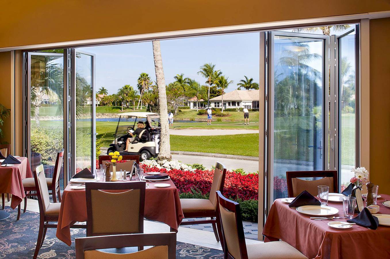 opening glass walls onto golf course