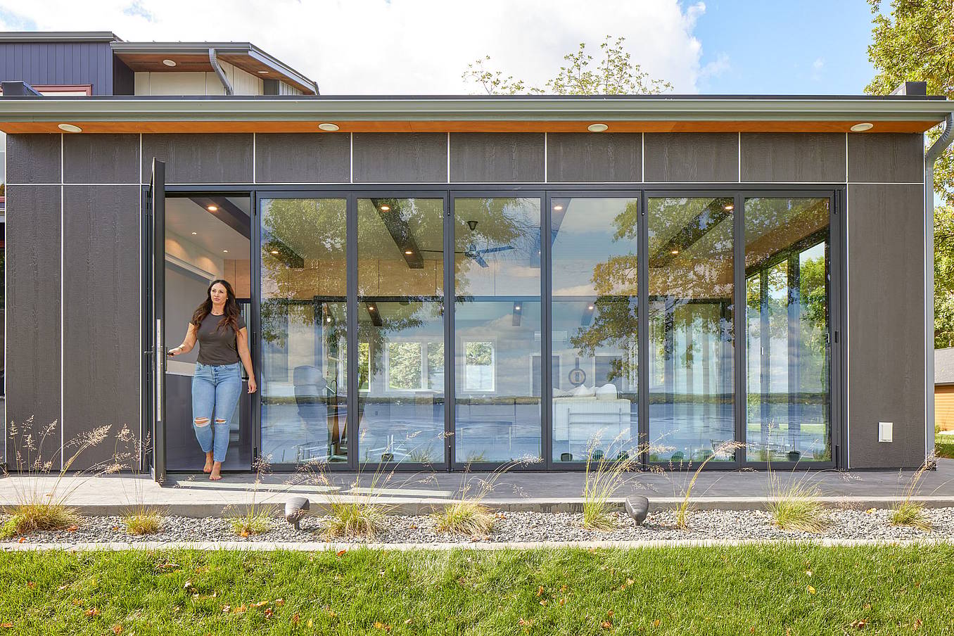 Swing door in folding glass wall systems