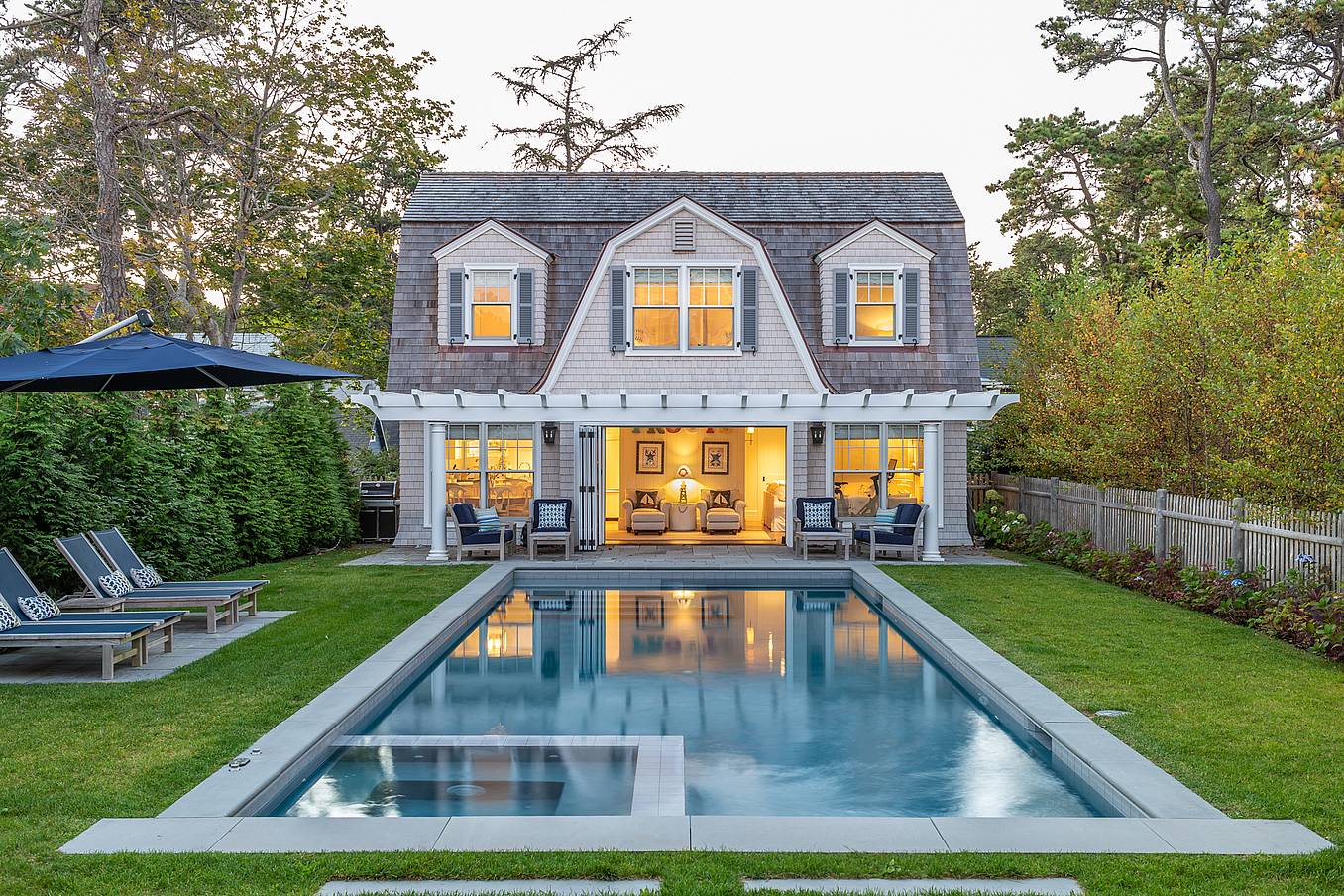 traditional pool house with operable glass walls
