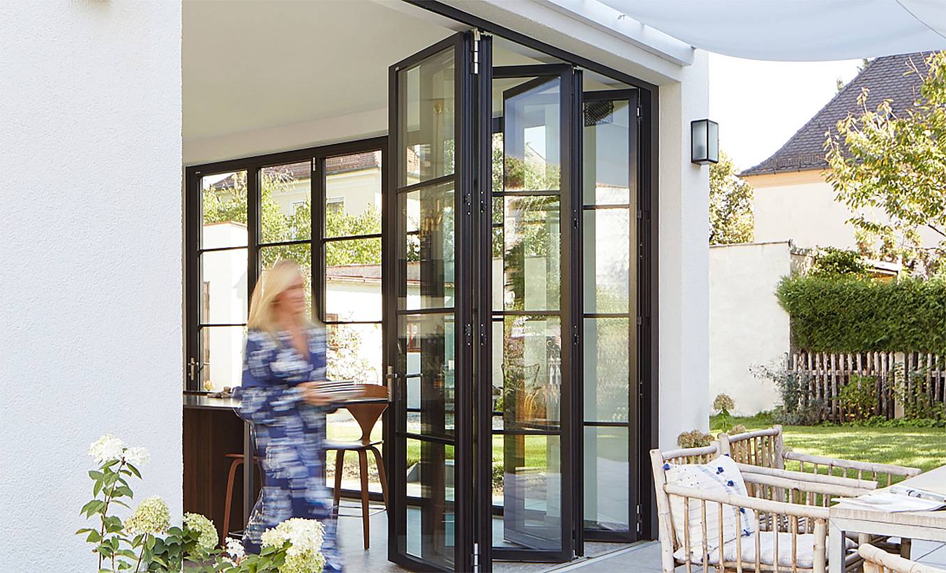 Modern Design with black framed steel look folding glass walls