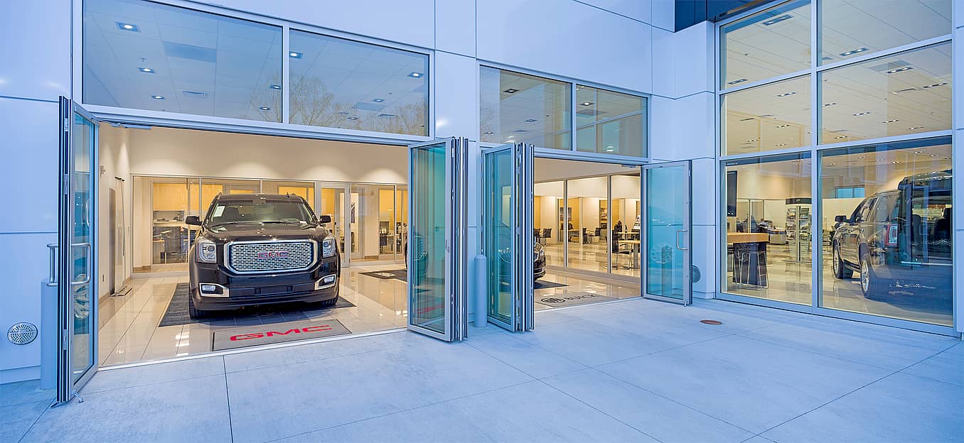 folding glass door systems in auto dealership design