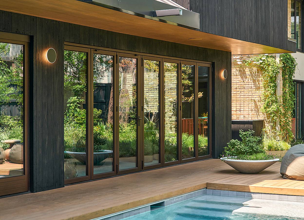 opening glass door system in pool house design
