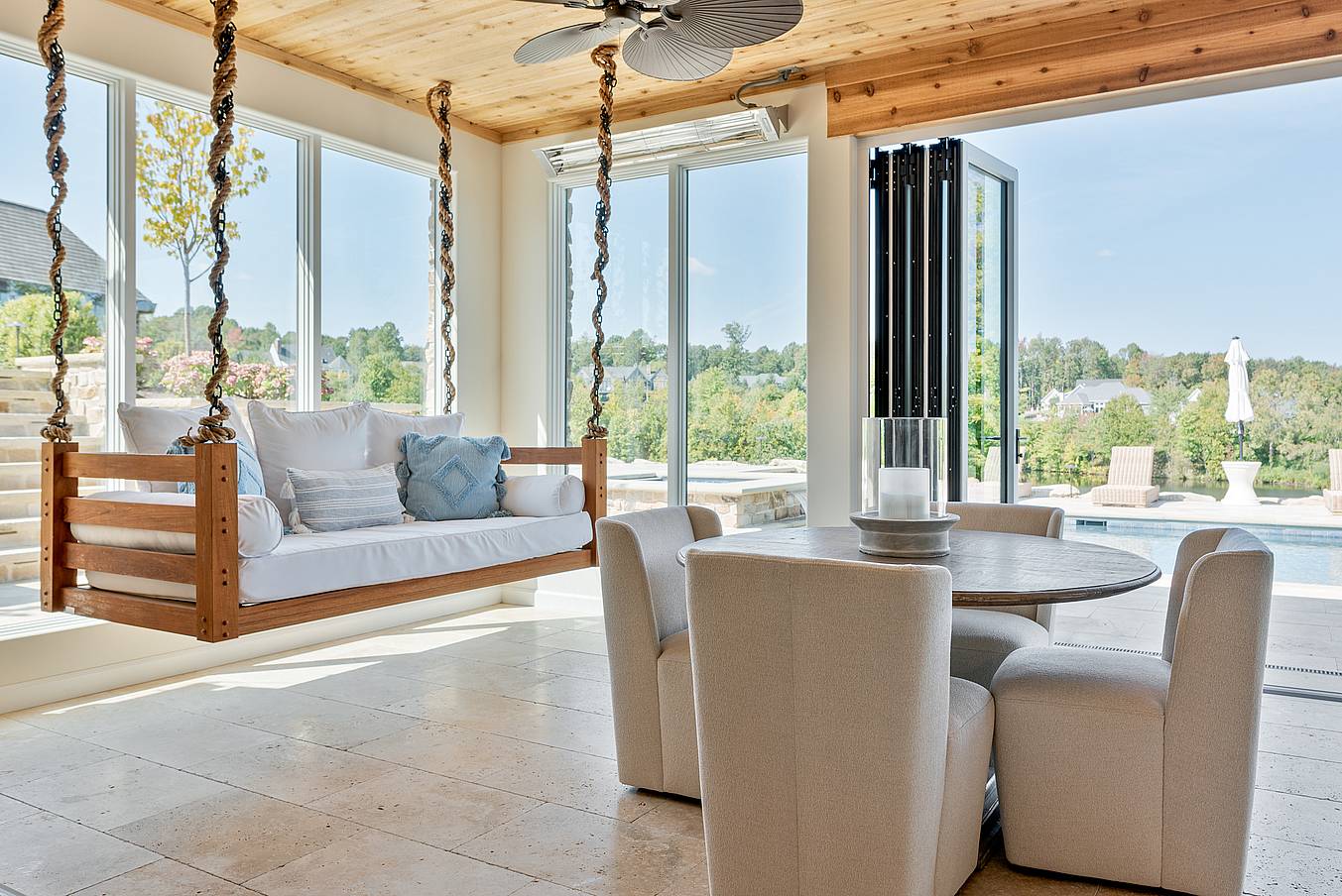 indoor-outdoor pool house design with clad bifold doors