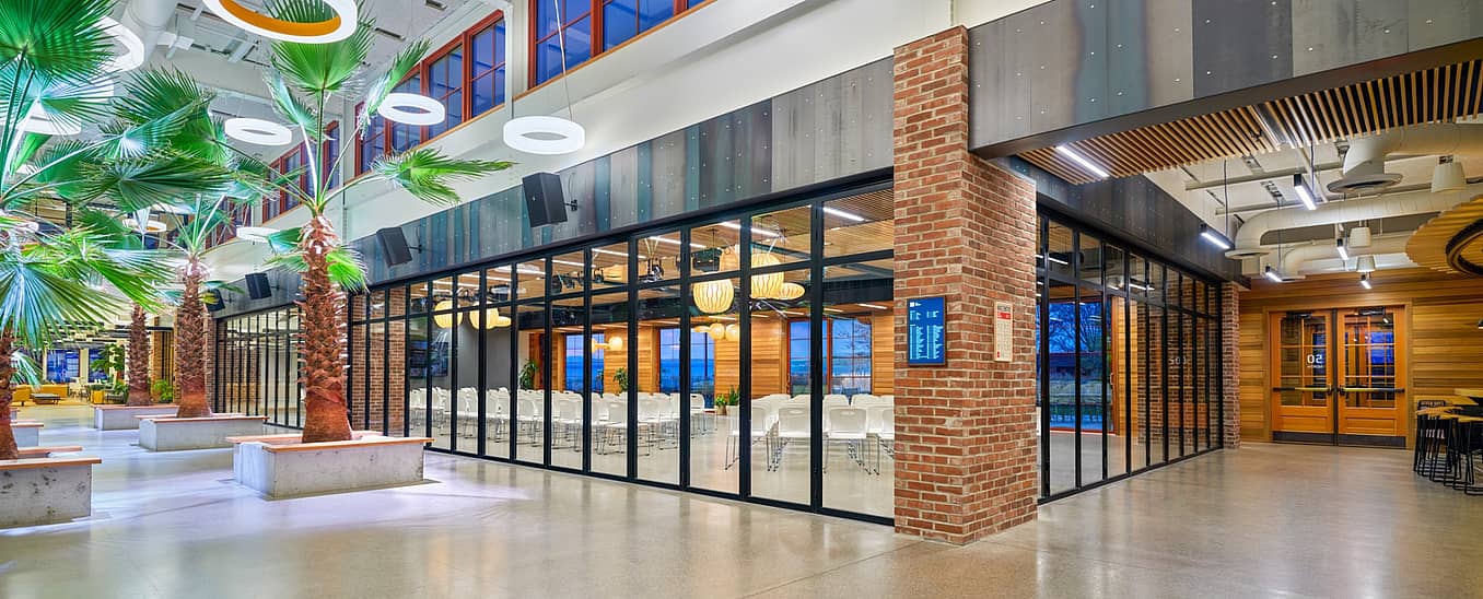 Interior folding glass walls across two sides of a corner