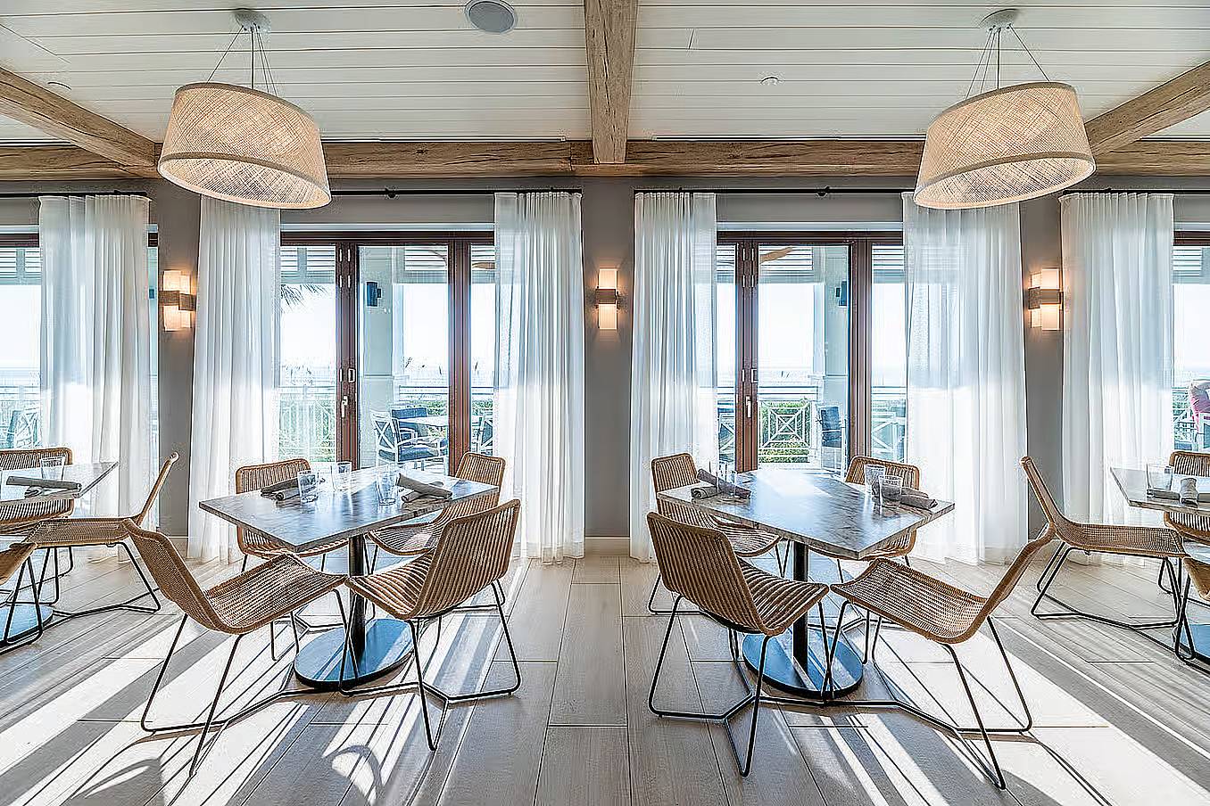 Miami-Dade hurricane-rated folding glass walls in hotel setting