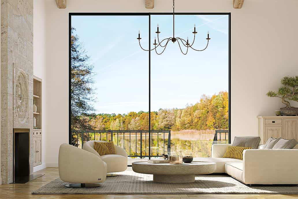 Large panel sliding glass walls offer an uninterrupted view of coastal mountains, lush greenery, and the ocean.