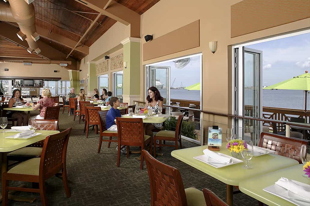 NanaWall impact-rated folding glass wall system at a waterfront restaurant in Port Canaveral, Florida, engineered for severe weather exposure