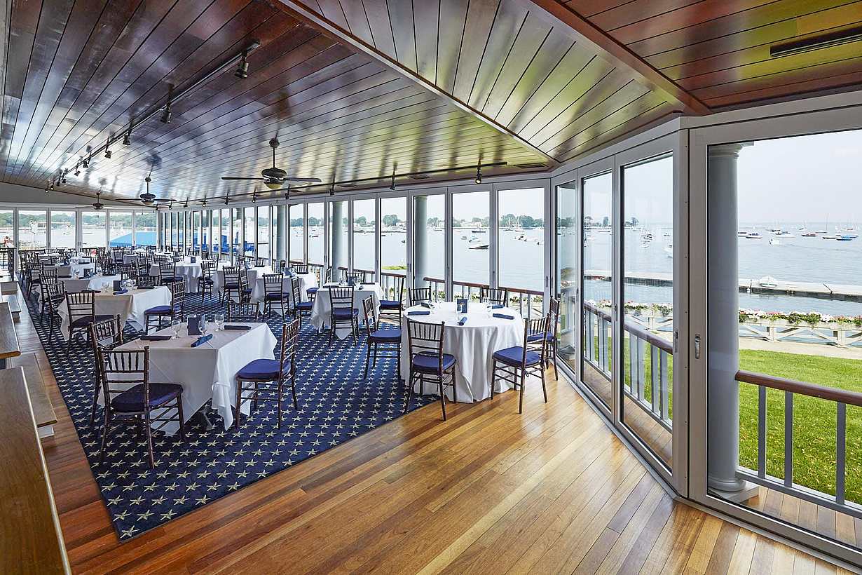 indoor outdoor dining at country club with commercial glass walls