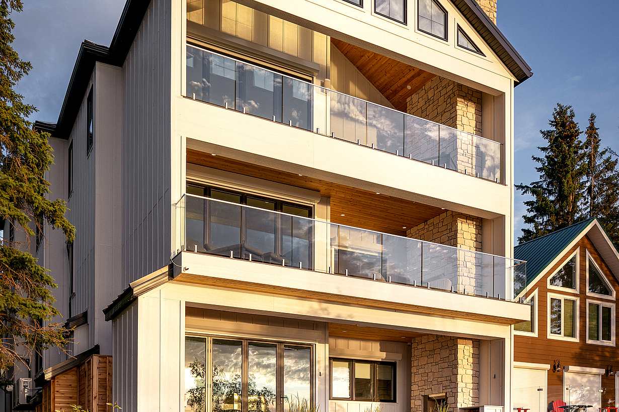 NanaWall energy-efficient folding glass doors on three levels of lakefront home