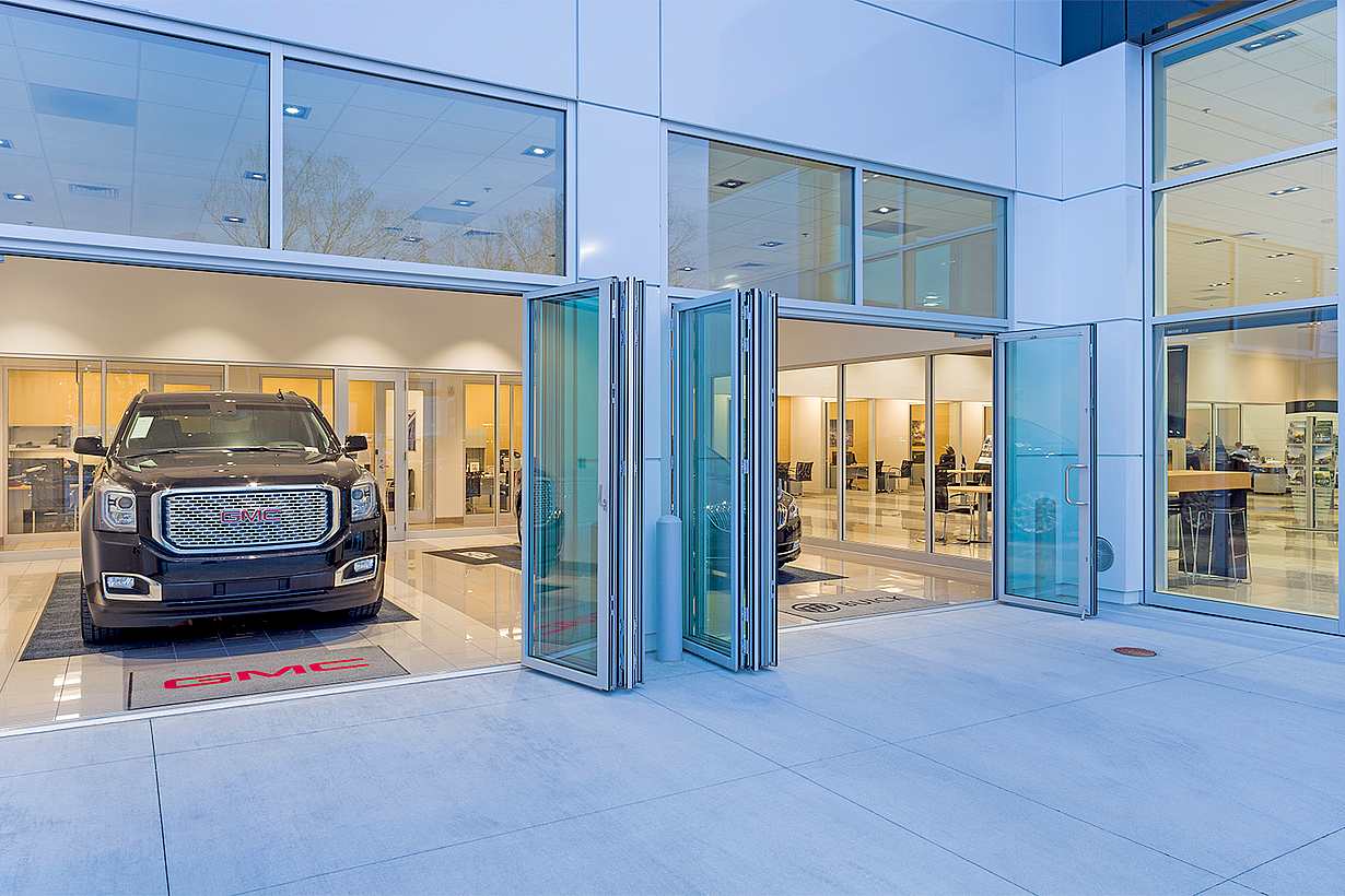 folding glass door systems in auto dealership design