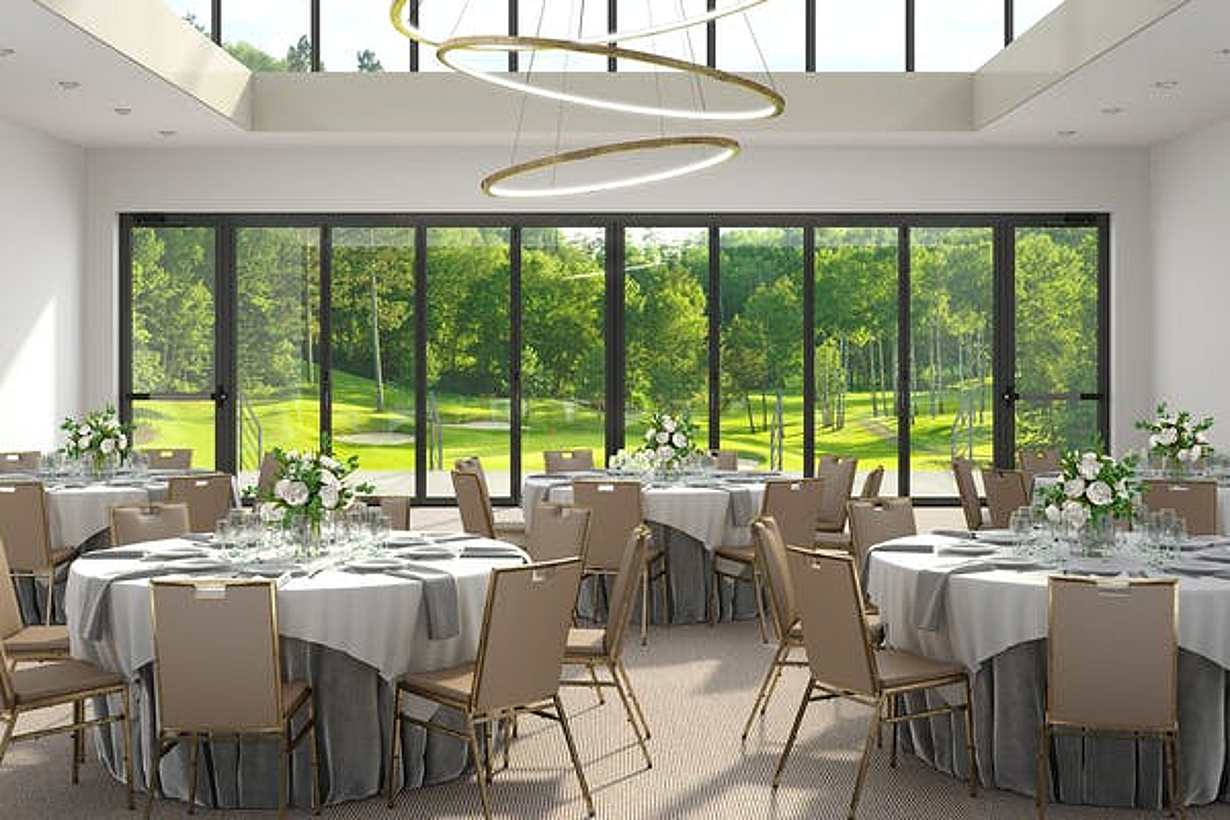 A banquet room with a view of a golf course, featuring commercial glass walls - closed doors