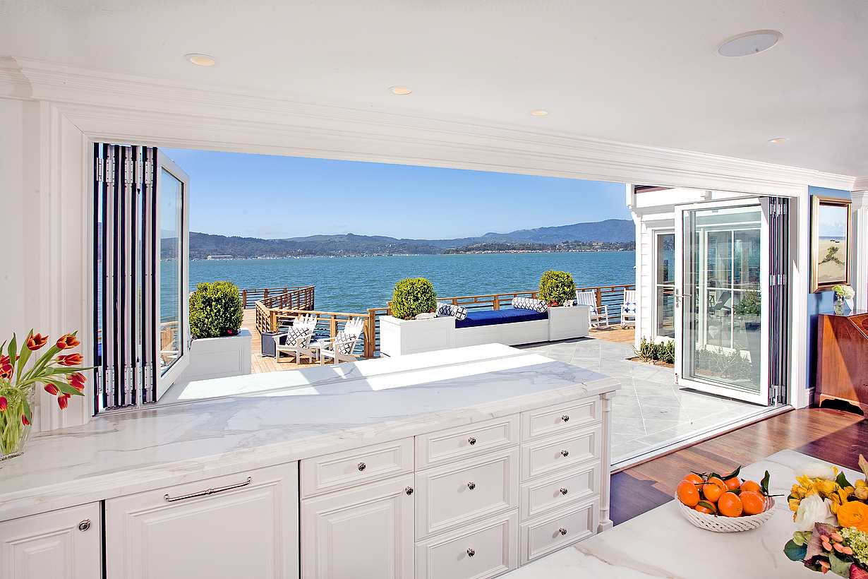 Indoor outdoor kitchen opening glass windows and floor-to-ceiling panels