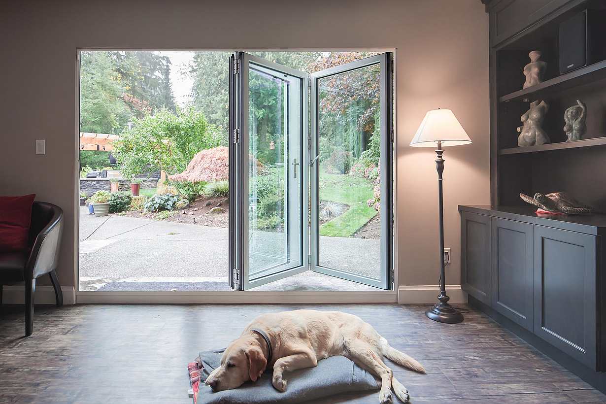 Retractable patio doors in South Surrey, BC integrate indoor and outdoor space via sleek small‑opening glass design