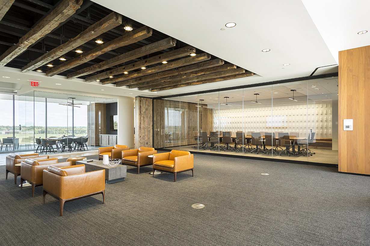 Office space with NanaWall PrivaSEE sliding partitions creating a meeting room within an open plan