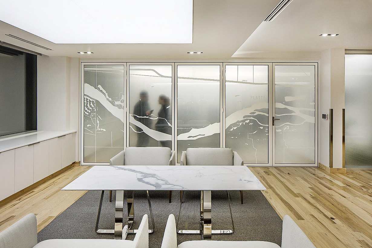 Law office reception area with NanaWall SL45 glass walls opening to adjacent workspaces