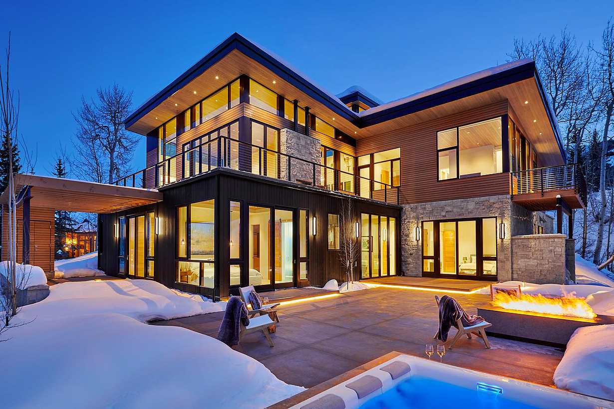 Retractable patio doors at Snowmass Village, CO residence improve energy efficiency and connect indoor-outdoor spaces