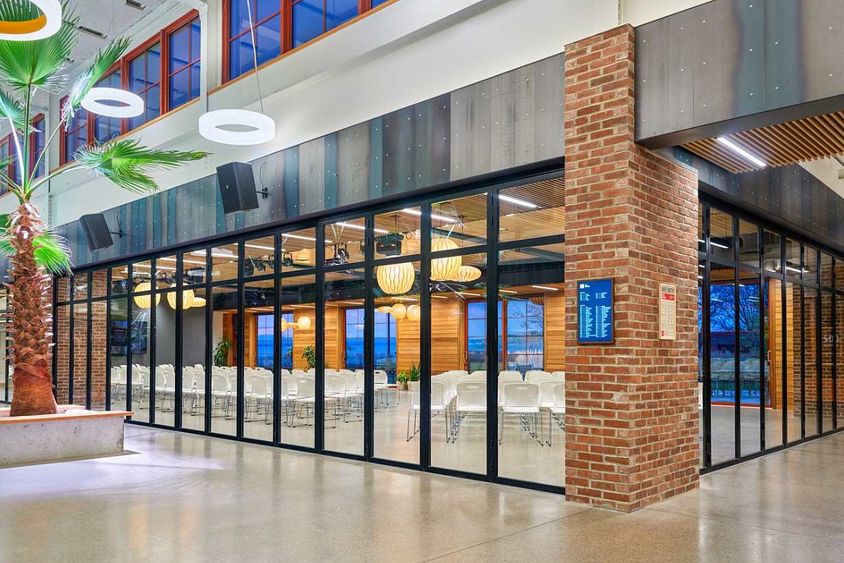 Interior folding glass walls across two sides of a corner
