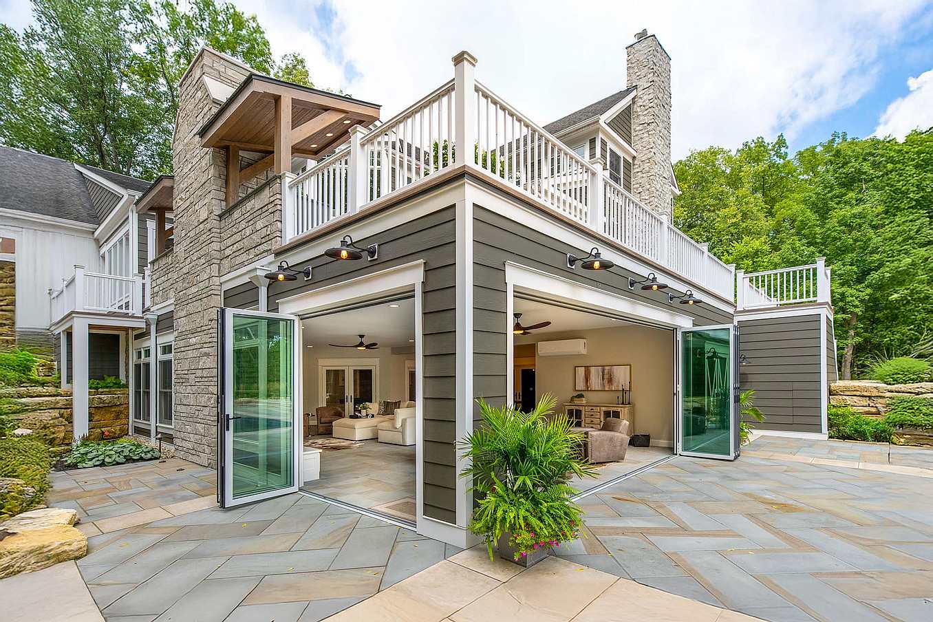Accordion glass doors at Columbus, OH River House, creating a seamless four-season sunroom with modern indoor-outdoor flow